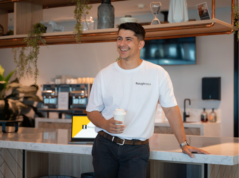 Oli, the director, having a coffee and laughing with employees